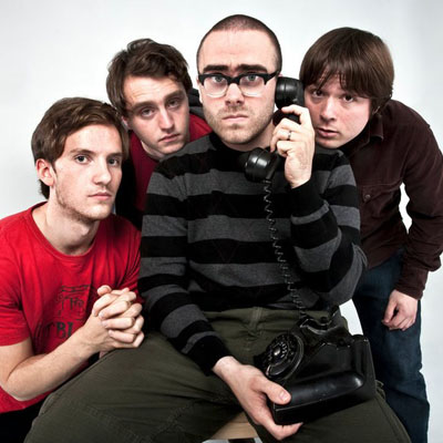 Four men with vintage telephone