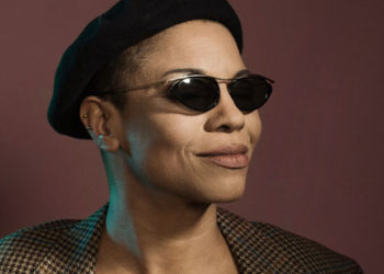 black woman with dark glasses and beret