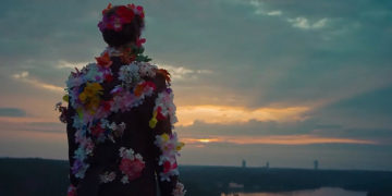 Man with flowers looking at skyline