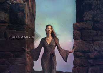 WOman stand between stone walls