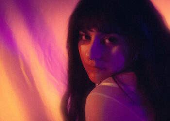 Portrait of Swedish artist Adeline with vibrant lighting effects.