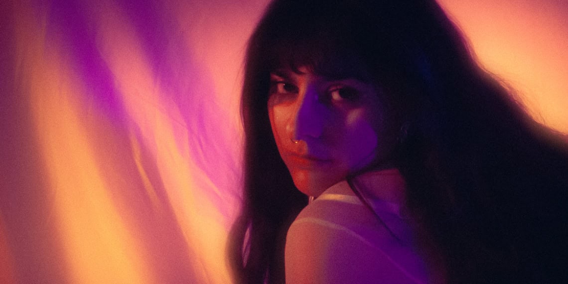 Portrait of Swedish artist Adeline with vibrant lighting effects.
